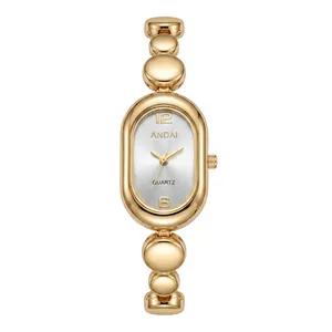 Elegant gold-toned oval dial women's watch featuring a stylish bean chain bracelet design.