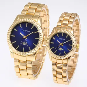 Detail view of gold-tone couple quartz watches with dark blue dials and steel bands