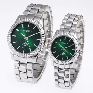 Detailed macro view of silver steel couple watches with emerald green sunburst dials