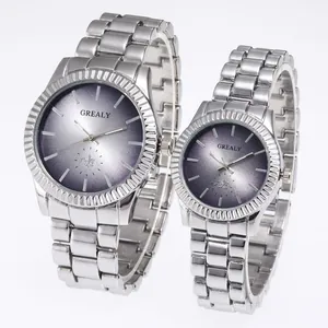 Close-up detail of GREALY couple watch set featuring silver stainless steel bands and gradient dials