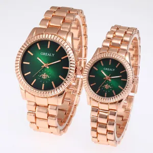 Detail view of rose gold couple watch set with green sunray dials and steel bands