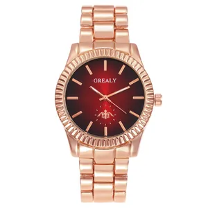 Close-up of rose gold quartz watch featuring a red gradient dial and fluted bezel