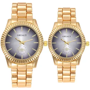 Close-up shot of elegant gold-plated couple's quartz watches with gradient grey dials