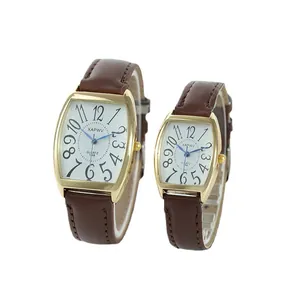 Elegant couple's quartz watches with brown leather straps and gold tonneau-shaped cases.