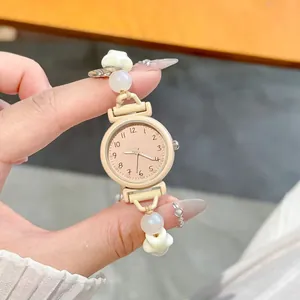 Close-up of cute dopamine style drawstring watch with pearl bracelet strap for students.