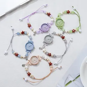 Detailed view of five colorful beaded bracelet watches with star charms and pull-cord bands