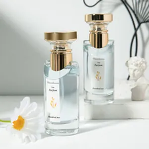 Λεπτομερής όψη δύο φιαλών αρώματος 50ml με χρυσά καπάκια και λουλουδάτα διακοσμητικά.