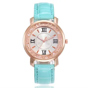 Close-up of elegant turquoise leather strap watch with sparkling rhinestone bezel detail