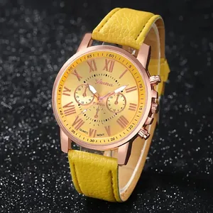 Detailed view of the yellow pebbled leather strap and rose gold Roman numeral watch dial