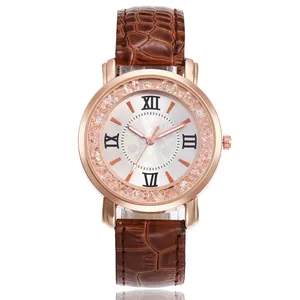 Close-up view of a rose gold quartz watch with rhinestones and brown leather strap