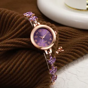 Detail of ladies quartz watch with purple leaf rhinestones and rose gold band
