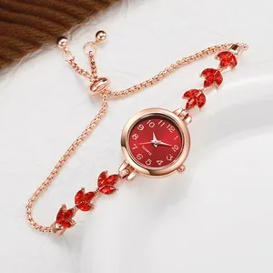 Close-up of rose gold lady's watch with red leaf crystals and adjustable pull-string