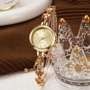 Elegant women's quartz bracelet watch with leaf-shaped yellow rhinestones and gold dial.
