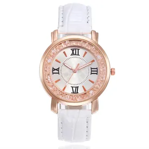 Detailed close-up view of a rose gold quartz watch featuring crystals and a white strap