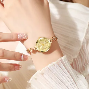 Elegant gold leaf rhinestone bracelet watch for women with small round analog dial.