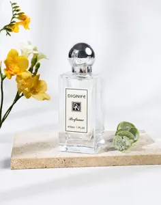 Elegant DIGNIFE 50ml Fruity Chypre perfume bottle on a beige stone with yellow flowers