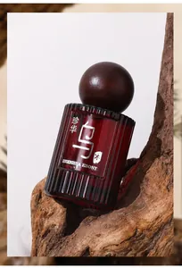 Detail of ZHENHUA Ebony perfume bottle with wooden cap on rough bark background