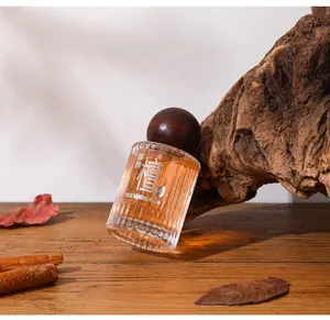 Detailed view of YIHE Sandalwood perfume bottle leaning on a natural wood block