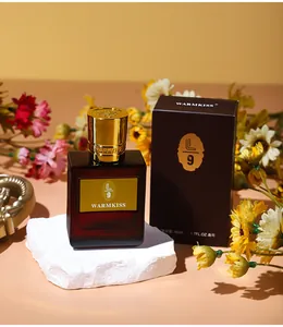 Detailed view of an elegant 50ml glass perfume bottle and box on a white stone base