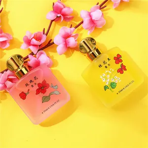 Due flaconi di profumo da 35 ml con aromi di osmanto e rosa e decorazioni floreali