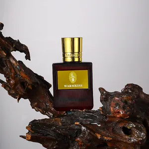 Elegant long-lasting women's perfume bottle with gold cap on a natural wood base