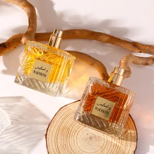 Premium Warmkiss Arabian unisex perfume bottles presented on a natural wooden slab display