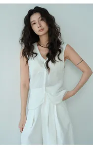 Close-up shot of a white minimalist knit mesh sleeveless vest worn by an Asian model