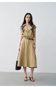 Full length view of model in khaki sleeveless dress with silk scarf and belt.