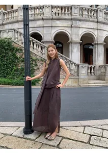 Asian model posing in dark brown irregular pleated midi skirt set outdoor street view