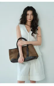 Elegant lifestyle detail of a white sleeveless mesh knit vest worn by an Asian model