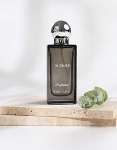 Detailed view of DIGNIFE 50ml elegant perfume bottle on a stone base with a green leaf prop
