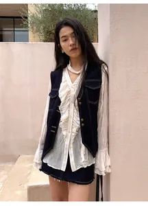 Gilet en jean vintage avec coutures contrastées pour femmes, porté avec une blouse à volants