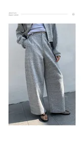 Macro view of high-waisted gray wide-leg sweatpants featuring a textured heathered fabric