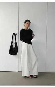 Full body shot of a woman wearing vintage white wide-leg casual denim pants for women