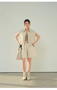 Full-body view of elegant beige linen wide-leg shorts paired with a chic matching vest