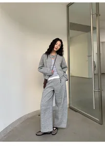 Asian model wearing a stylish grey casual two-piece sweatshirt and wide-leg trousers set