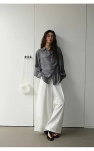 Full length view of stylish retro white wide-leg denim trousers for women in spring