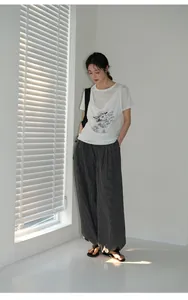 Woman wearing retro checkered loose casual pants with white blinds background