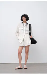 Model wears breathable white tencel ramie elastic waist shorts with hooded shirt outfit.