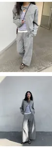 Asian model in a chic gray heathered casual sweatshirt and wide-leg trousers two-piece set.