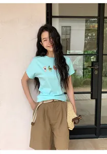 Casual women's linen wide-leg shorts with woven belt detail featured in a summer outfit