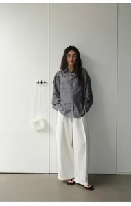 Full look of retro wide-leg white casual pants for women with minimalist styling