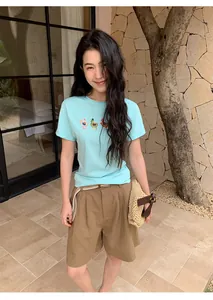 Women's casual brown linen wide-leg shorts with a woven belt styled in a summer outfit