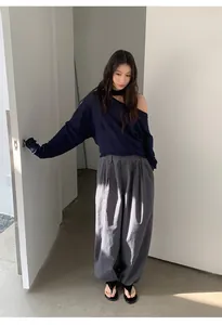 Full view of women's high-waist retro checkered loose harem pants in a minimalist room