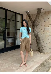Stylish brown linen wide-leg casual shorts for women paired with a woven belt accessory