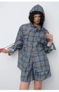 Asian female model wearing a casual blue plaid hooded shirt with matching shorts set