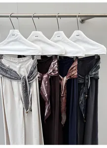 Detailweergave van soepele casual broeken in vier kleuren met zijden sjaalriemen.
