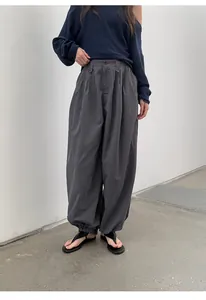 Full length view of women's retro plaid loose jogger pants with elastic waist band