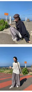 Loose-fit wide-leg grey casual pants for women in an outdoor coastal setting