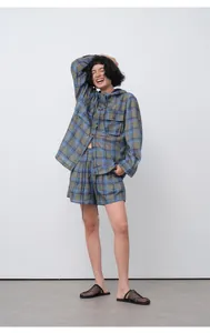 Asian model posing in a blue plaid tencel ramie casual hooded shirt and shorts set.